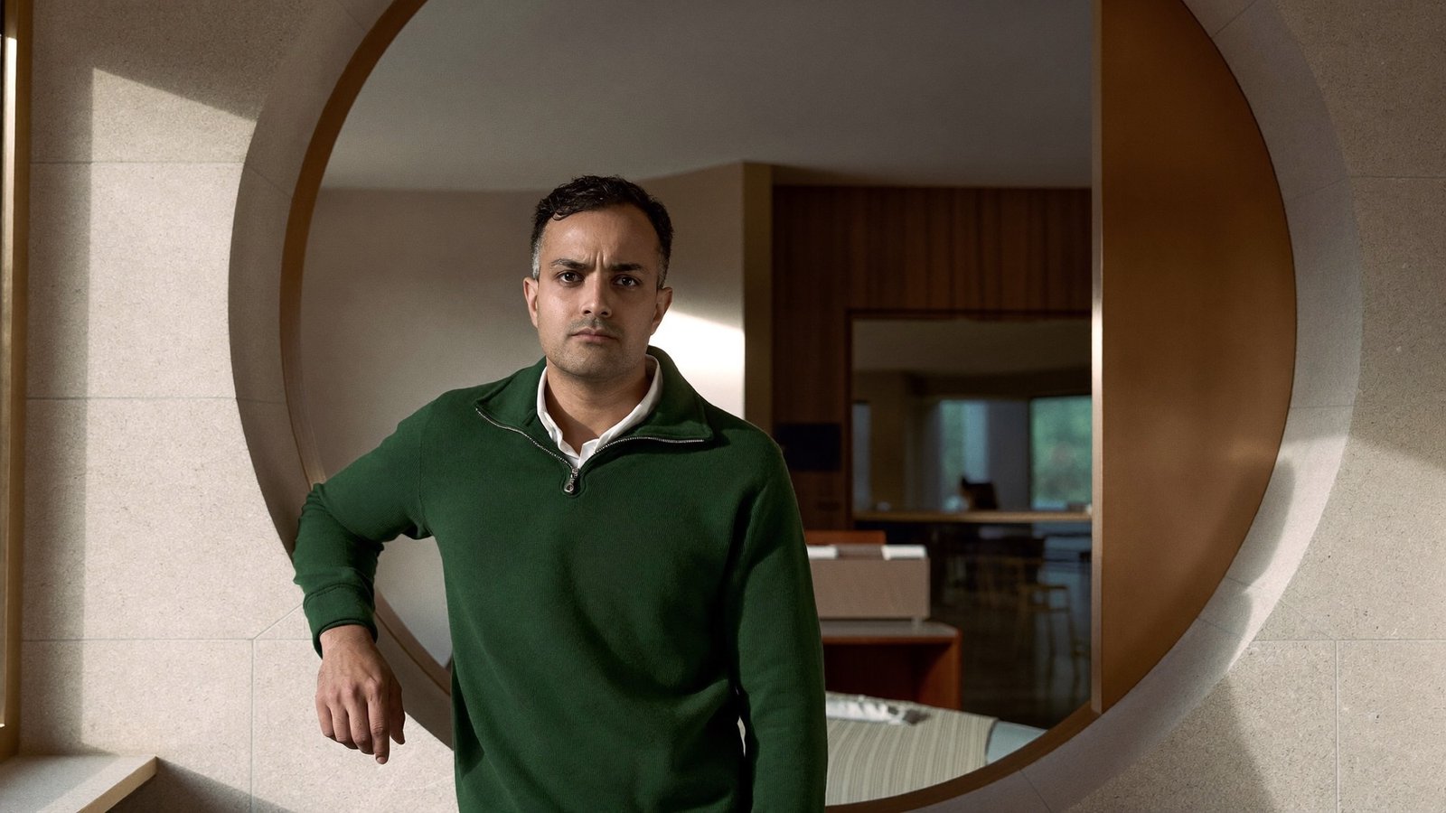 Dr. Aarav Mehta standing within a circular stone archway inside his private clinic